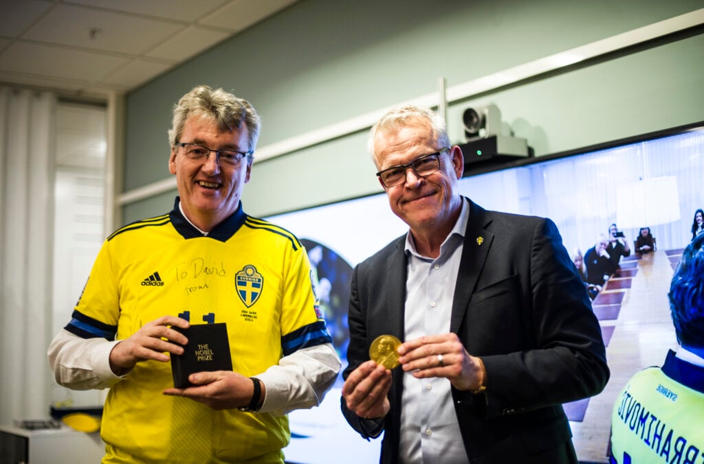 David MacMillan standing with Sweden national football team manager Janne Andersson.