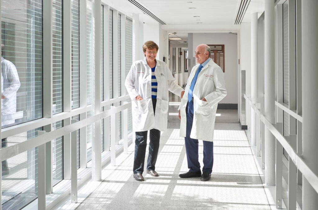 Woman and man wearing lab shirts