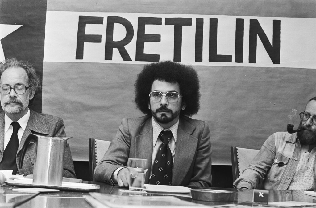 Three men sitting at a table