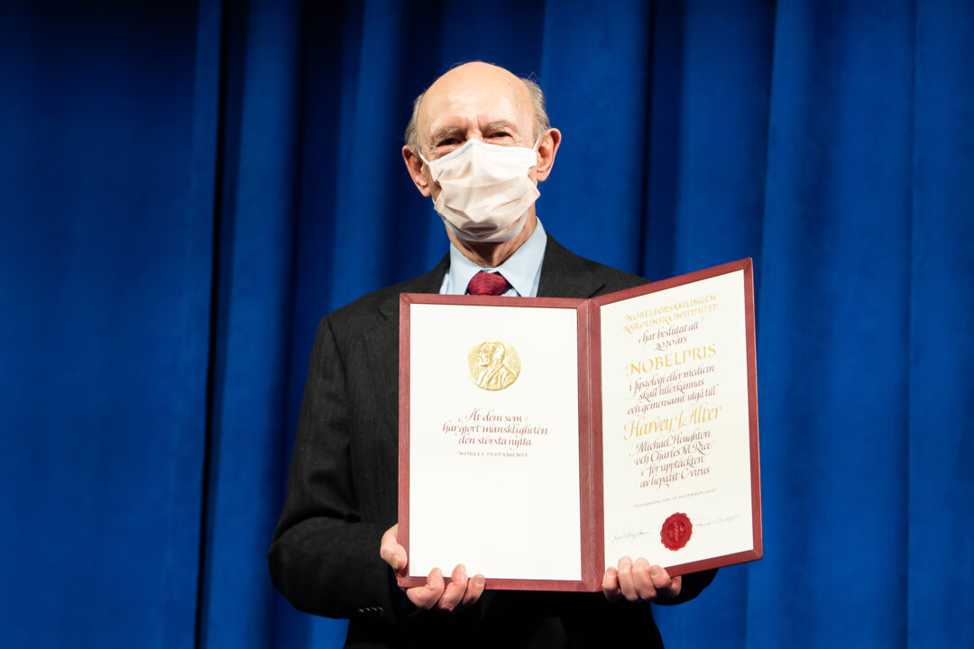 Harvey J. Alter showing his Nobel Prize diploma.