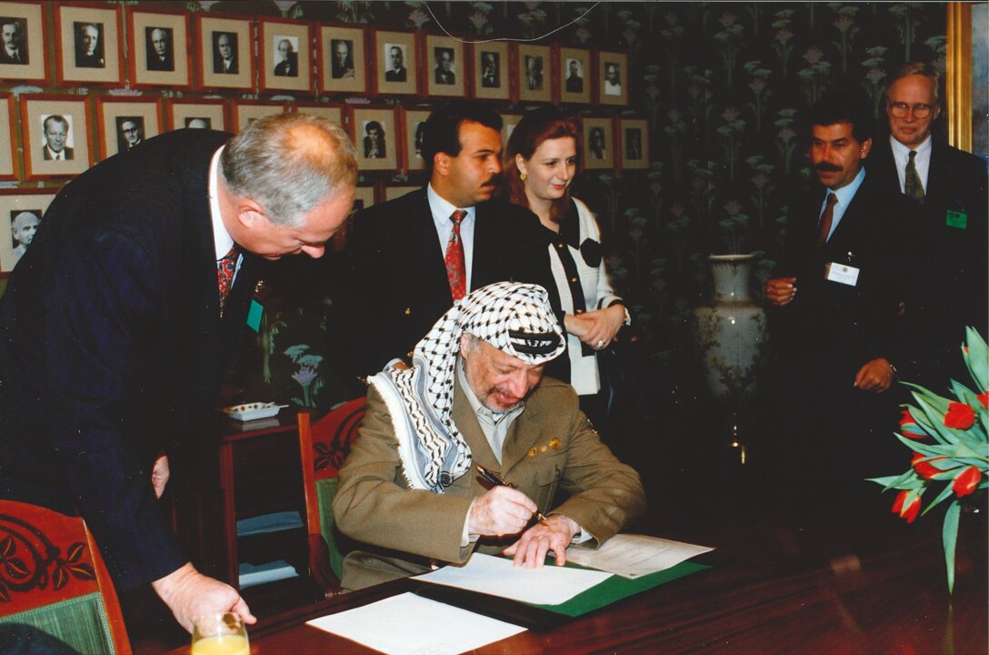 Yasser Arafat signing a guest book