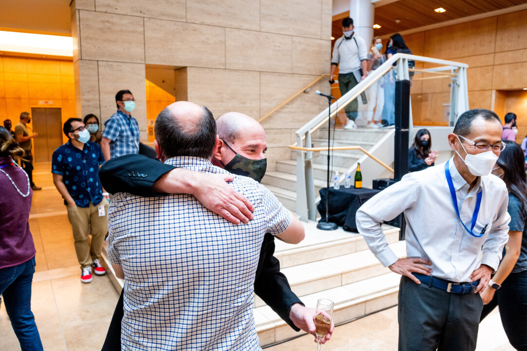 David Julius hugs a colleague at UCSF’s Mission Bay campus