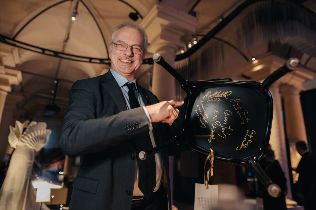 Morten Meldal signs a chair at the Nobel Prize Museum