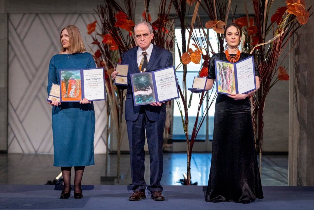 Representatives of the Nobel Peace Prize laureates for 2022 with their medals and diplomas
