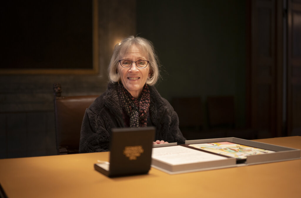 Claudia Goldin with her diploma and medal