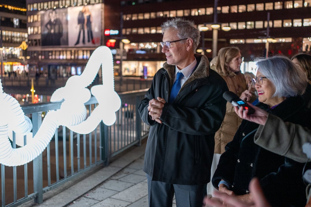 Aman and a woman looking at a light installation