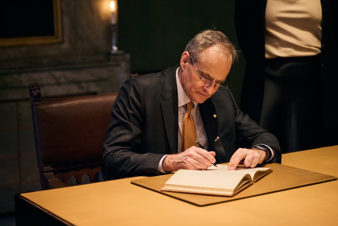 Man signing guestbook