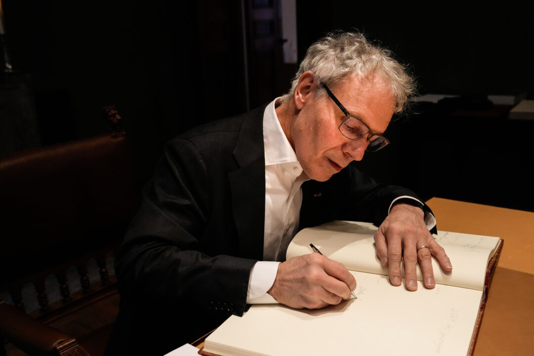 Man signing guestbook