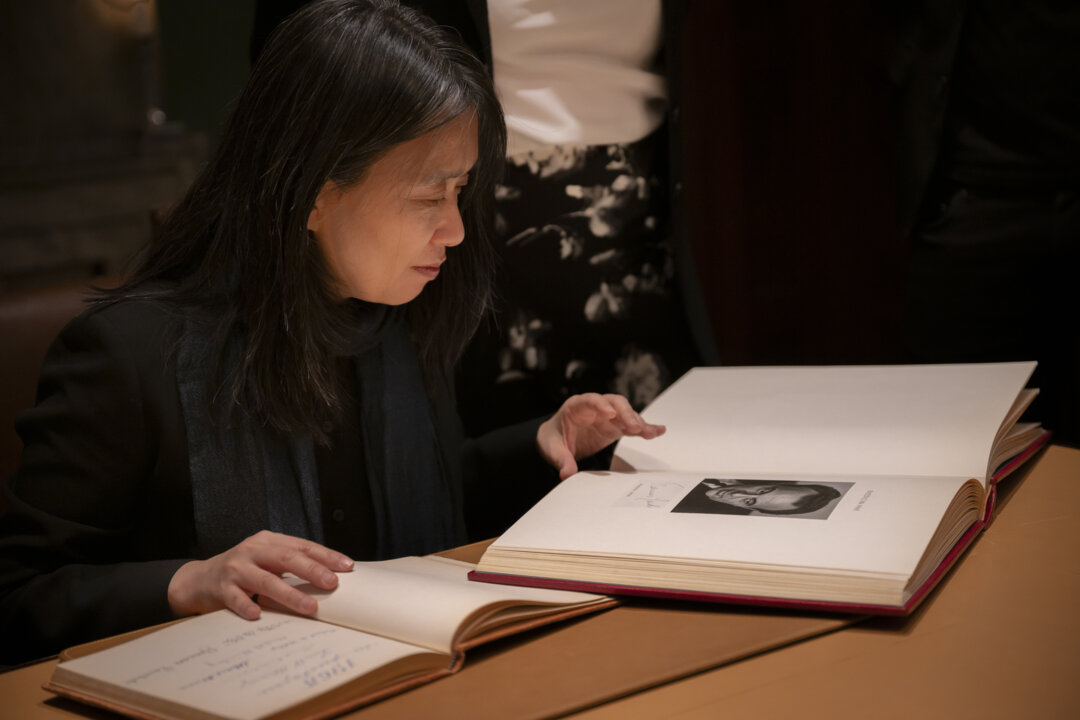 A woman is looking in a guestbook