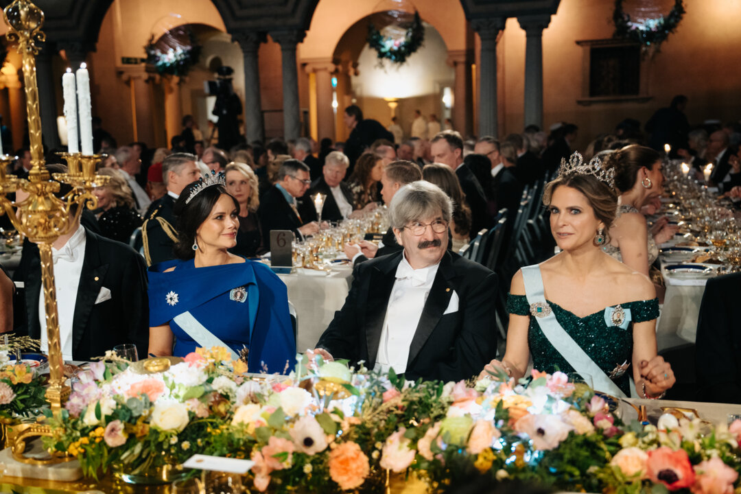 Two princesses and a laureate at a table