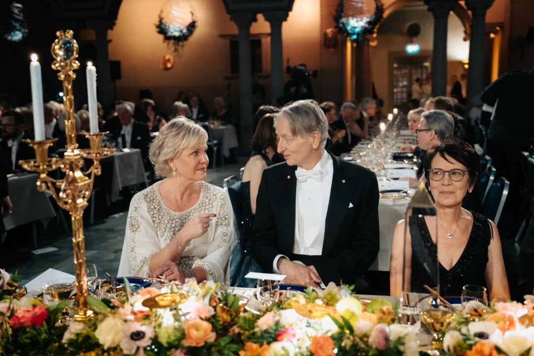 Two women and a man at a banquet table