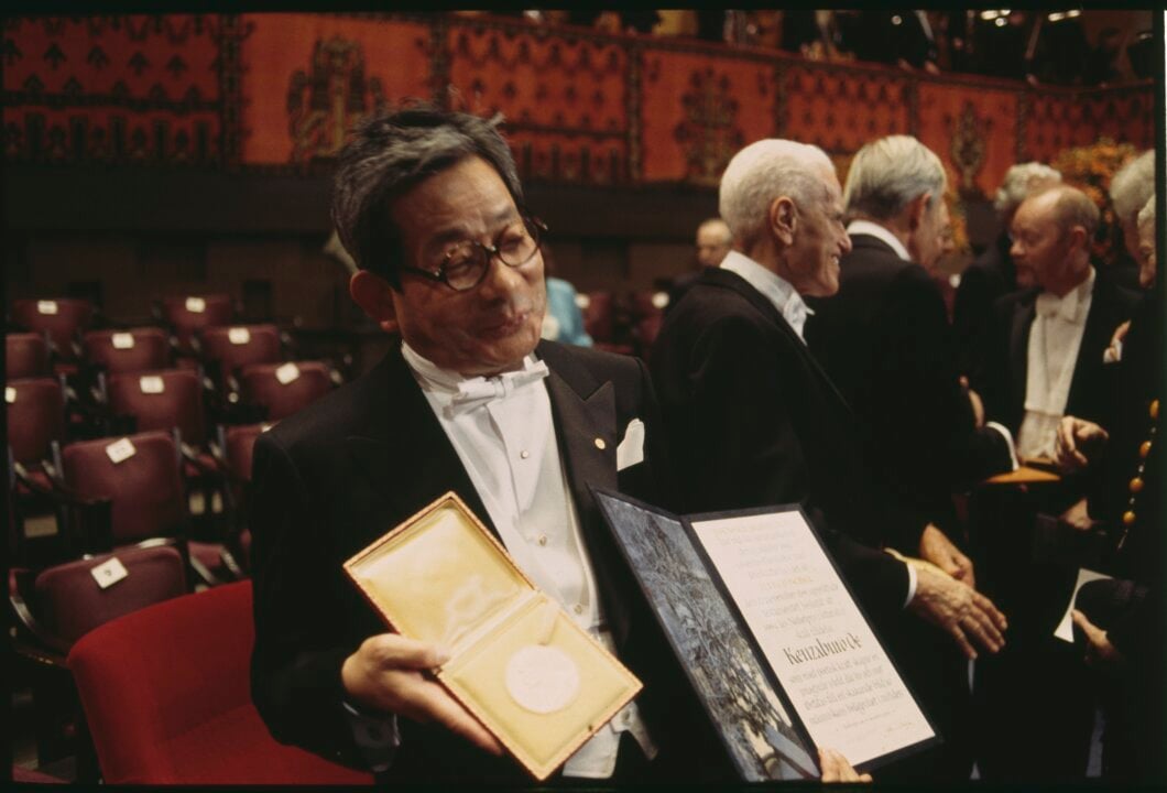 Kenzaburo Oe showing his Nobel Prize medal and diploma