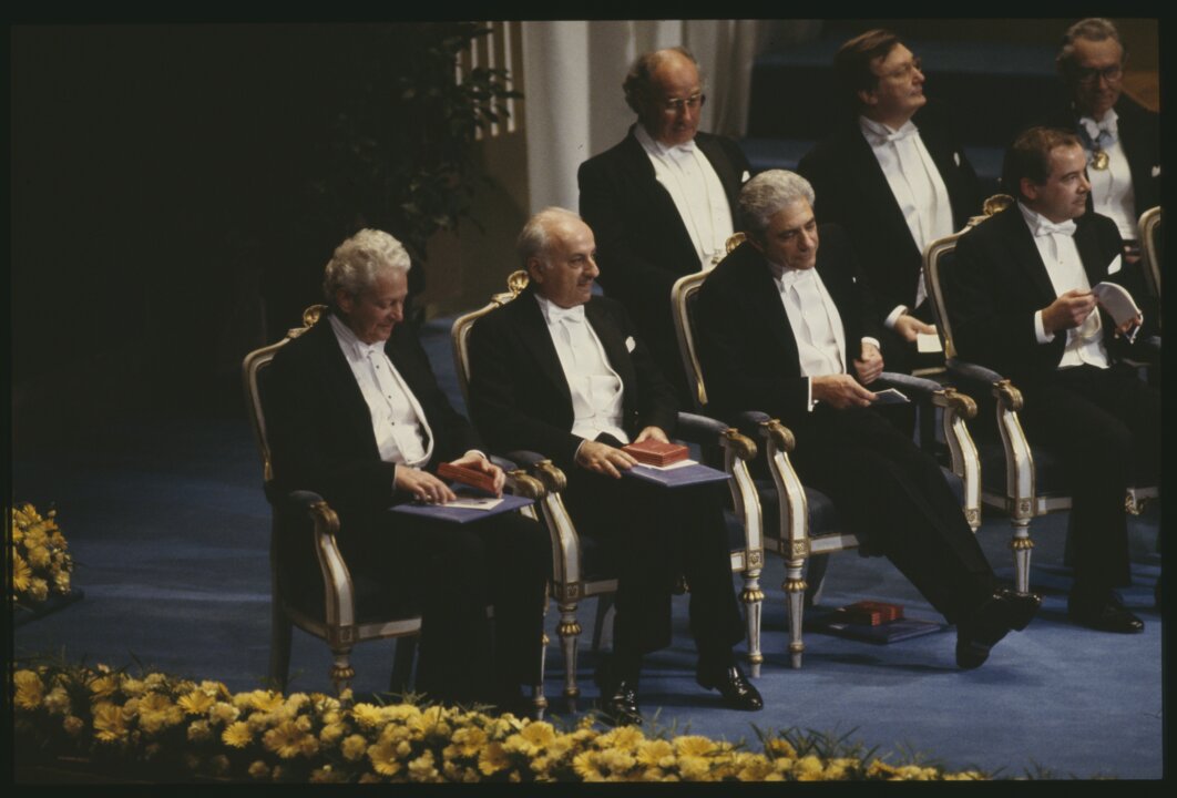 Four men sitting on a stage