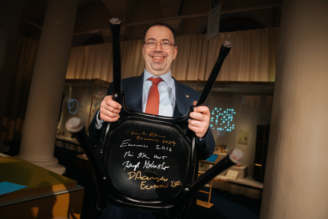 A man showing a signed chair