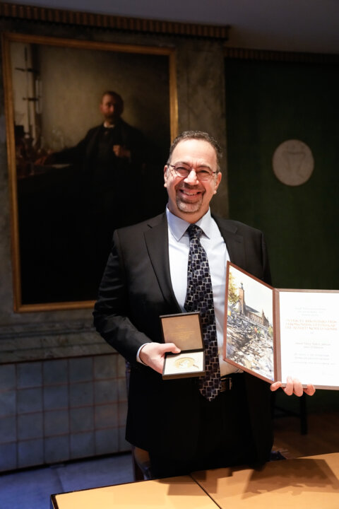 Daron Acemoglu with his diploma and medal