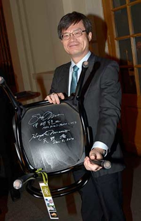 Like many Nobel Laureates before him, Hiroshi Amano autographs a chair at Bistro Nobel at the Nobel Museum in Stockholm, 6 December 2014.