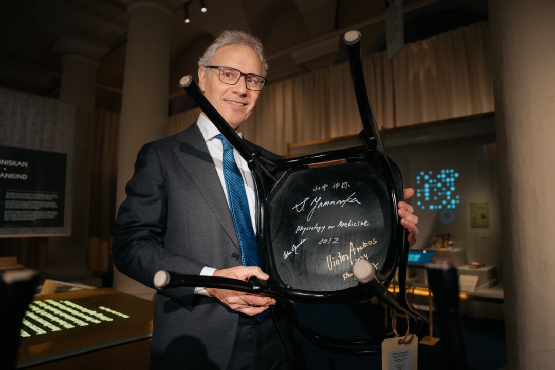 A man showing a signed chair