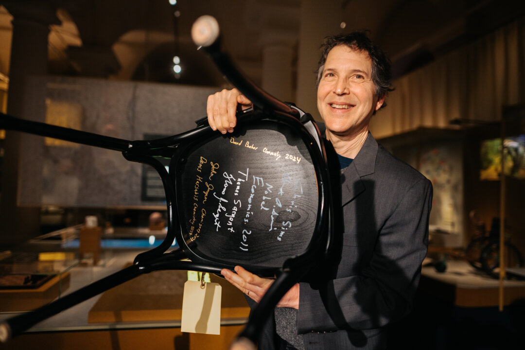 A man showing a signed chair