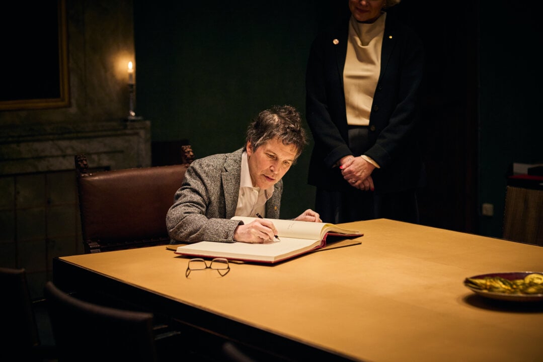 A man signing a guest book