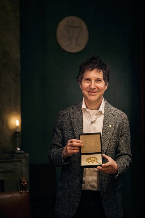 A man showing a medal