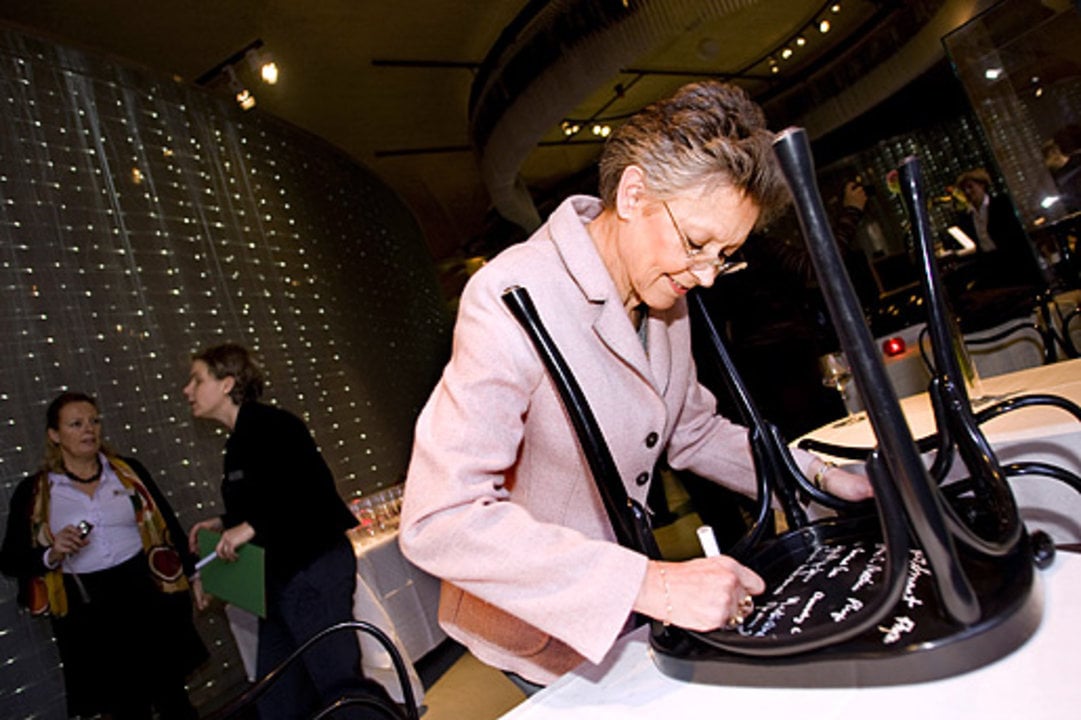 Françoise Barré-Sinoussi, like many Nobel Laureates before her, autographs a chair