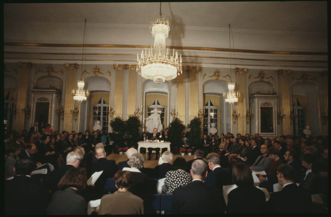 A man delivering a lecture in front of an audience