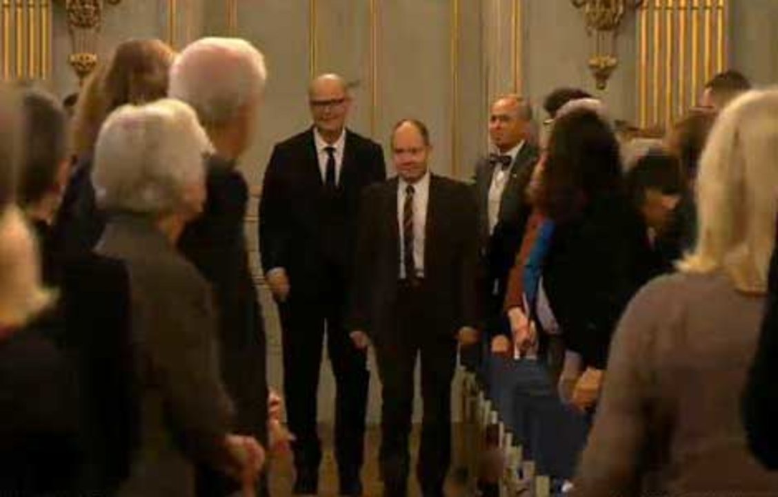 Patrick Modiano and Peter Englund, Permanent Secretary of the Swedish Academy, enter the hall at the Swedish Academy in Stockholm, 7 December 2014.
