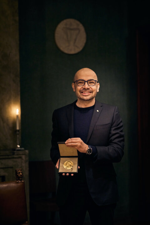 Demis Hassabis showing his medal