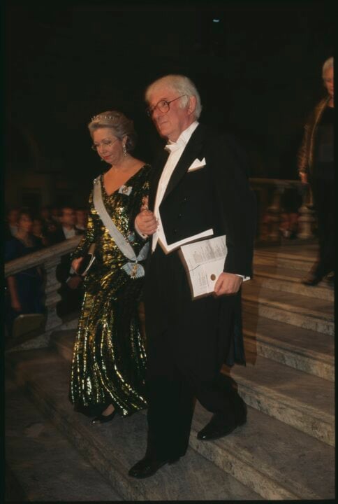 A man and a woman proceed down stairs