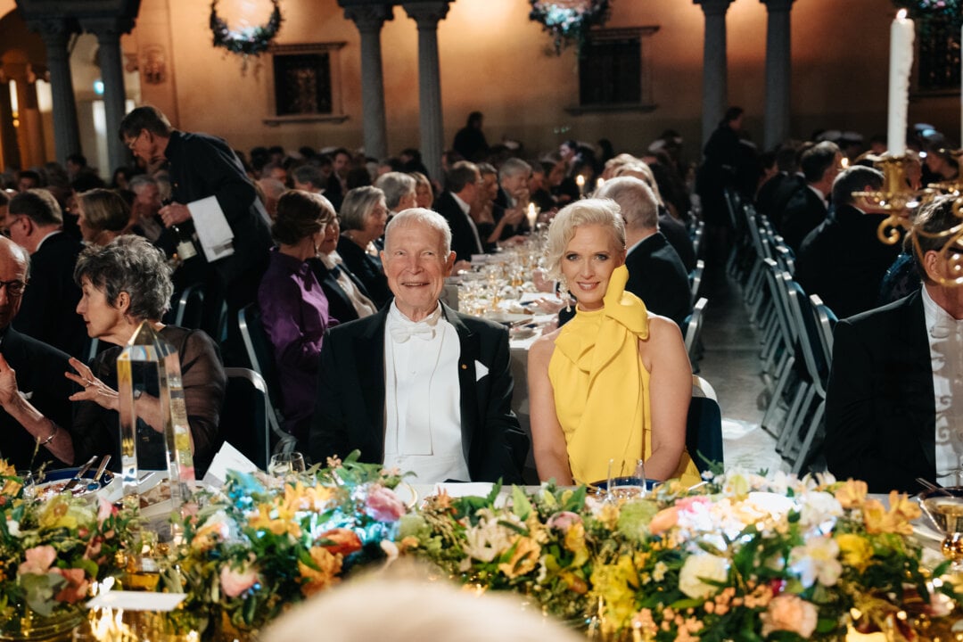 A man and a woman sitting at a banquet table