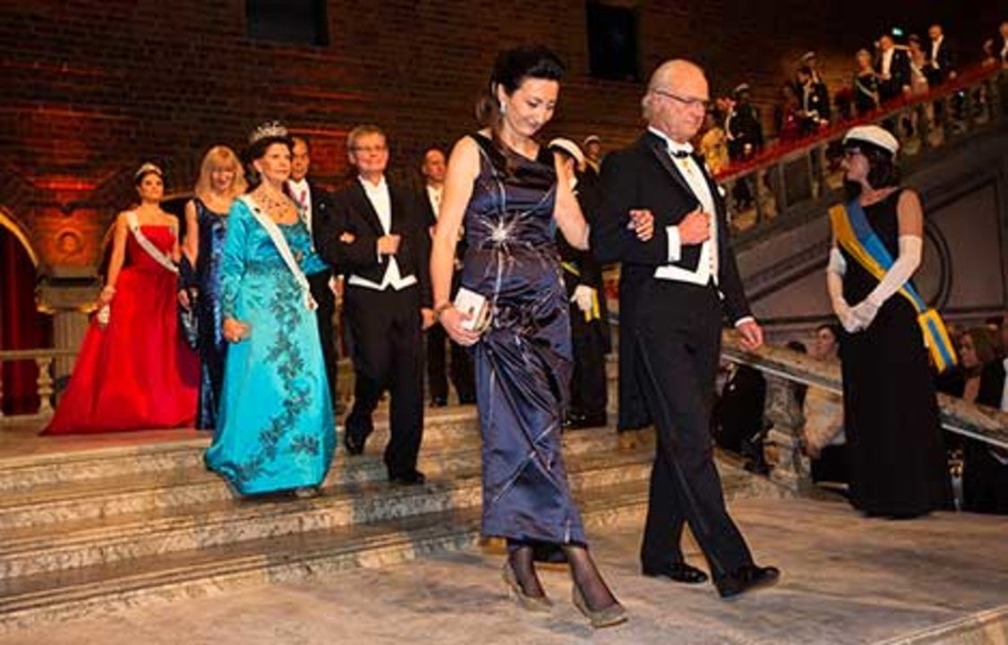 Sweden's King Carl XVI Gustaf and May-Britt Moser proceed into the Blue Hall of the Stockholm City Hall for the Nobel Banquet.