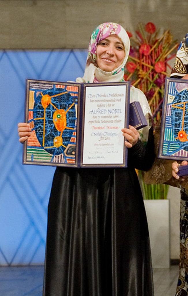 A woman showing a diploma