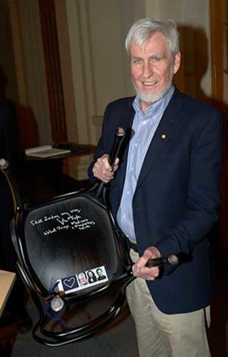 Like many Nobel Laureates before him, John O'Keefe autographs a chair at Bistro Nobel at the Nobel Museum in Stockholm, 6 December 2014.