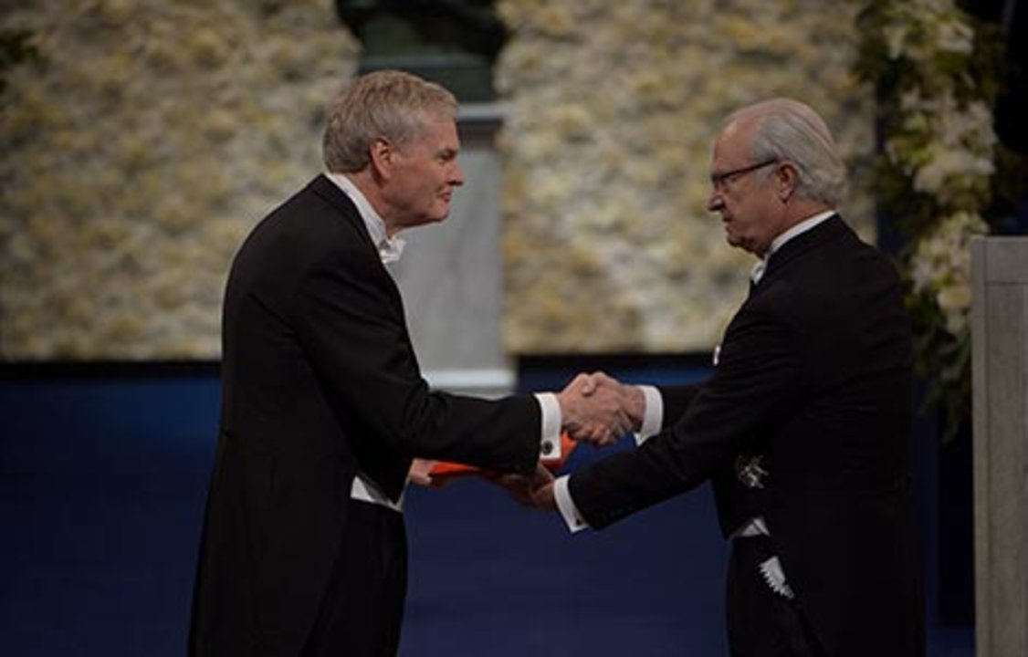 Michael W. Young receiving his Nobel Prize from H.M. King Carl XVI Gustaf of Sweden