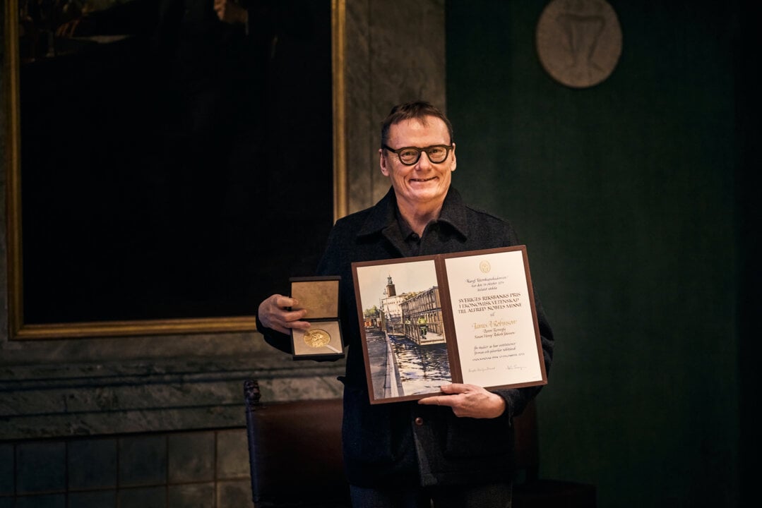 James A. Robinson with his diploma and medal