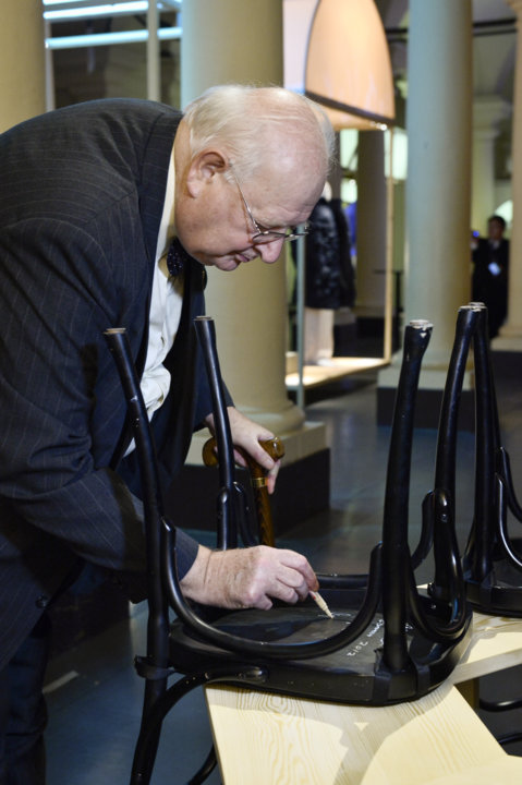 Like many Laureates before him, Angus Deaton autographs a chair at Bistro Nobel at the Nobel Museum in Stockholm.