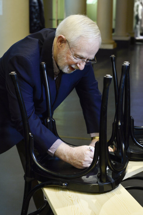 Like many Nobel Laureates before him, Arthur B. McDonald autographs a chair at Bistro Nobel at the Nobel Museum in Stockholm.