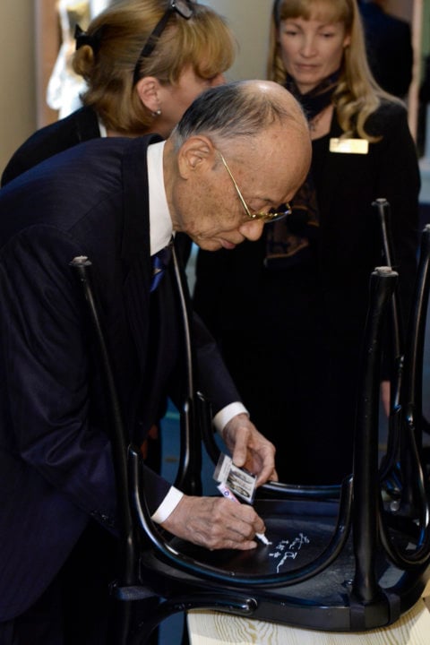 Like many Nobel Laureates before him, Satoshi Ōmura autographs a chair at Bistro Nobel at the Nobel Museum in Stockholm.