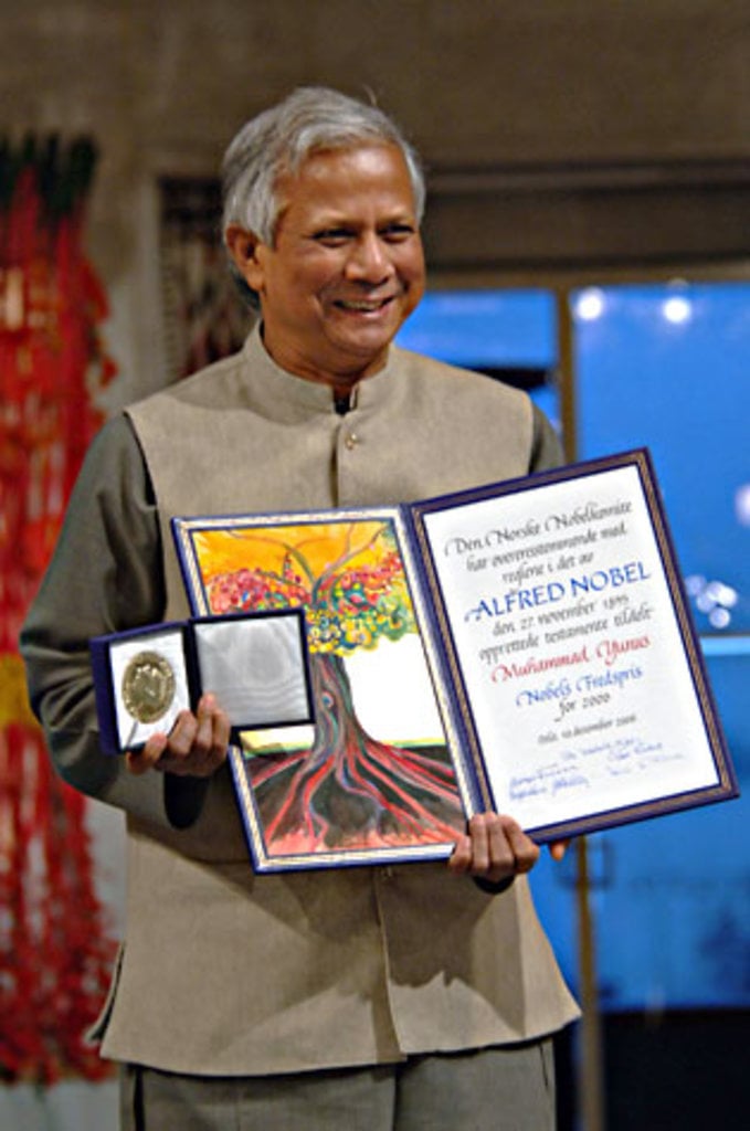 A man showing a diploma and a medal