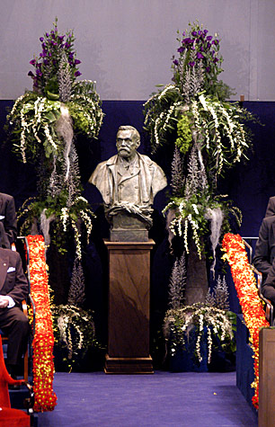 A bust of Alfred Nobel takes centre stage, surrounded by beautiful flowers