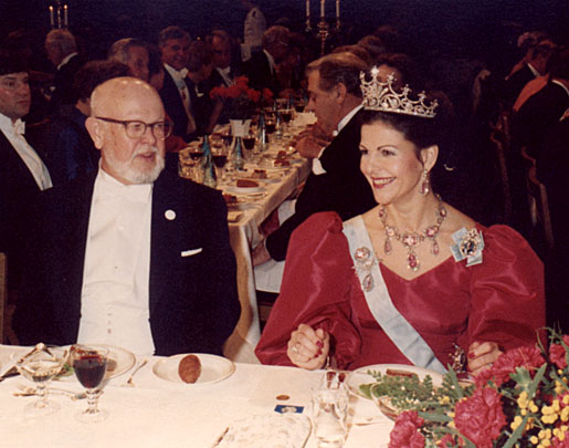 HM Queen Silvia of Sweden flashes a smile while conversing with William Alfred Fowler at the Nobel Banquet