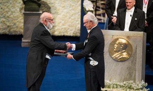 François Englert receiving his Nobel Prize from His Majesty King Carl XVI Gustaf of Sweden