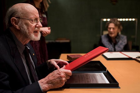 William C. Campbell takes a closer look at his Nobel diploma during his visit to the Nobel Foundation.