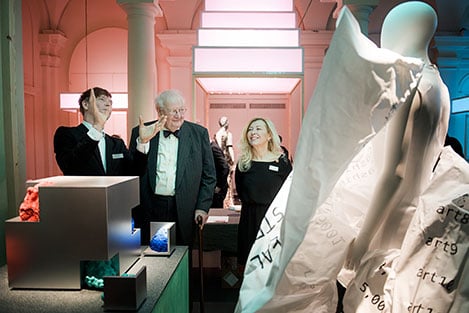 Angus Deaton (middle) looks at how his work was interpreted by fashion students as part of the exhibition Nobel Creations.
