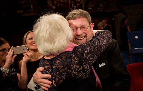 Mrs Berit Kosterlitz gives her husband, Physics Laureate J. Michael Kosterlitz, a hug