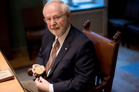Arthur B. McDonald showing his Nobel Medal during his visit to the Nobel Foundation on 12 December 2015.