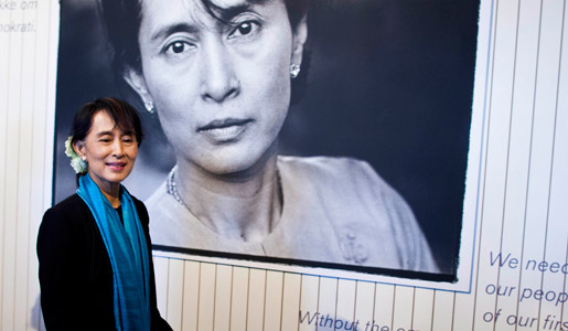 Aung San Suu Kyi in front of a photo of herself at the exhibition at Nobel Peace Center in Oslo