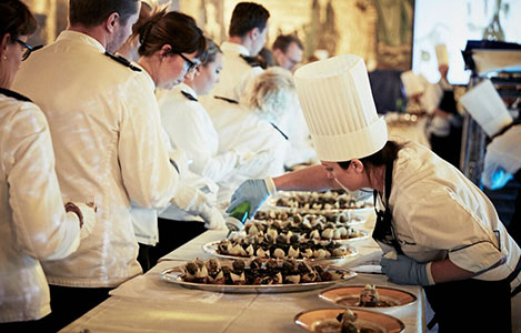 The servers wait in the Golden Hall for the serving dishes to be prepared