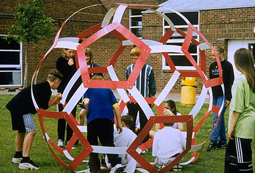 Schoolchildren in Sussex constructing a giant buckyball out of plastic strips