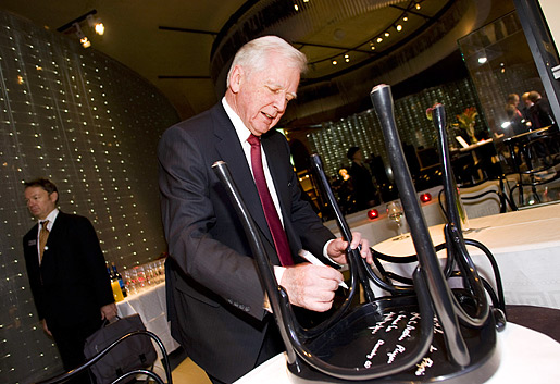 Harald zur Hausen signing a chair